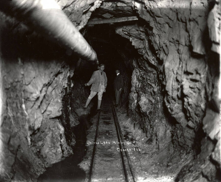 Two men standing underground inside the mine at the United Lead Mining Company in Osborn, Idaho.