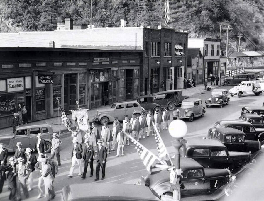 The Eagles marching in the Elks Roundup parade in Wallace, Idaho. Cars line the streets.