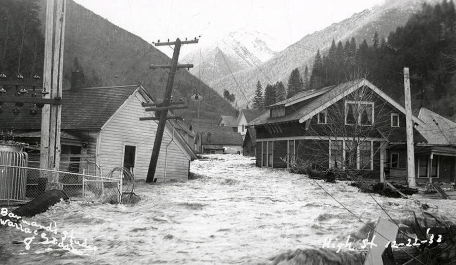 View of High Street during the Placer Creek flood in Wallace, Idaho. Houses line the street.