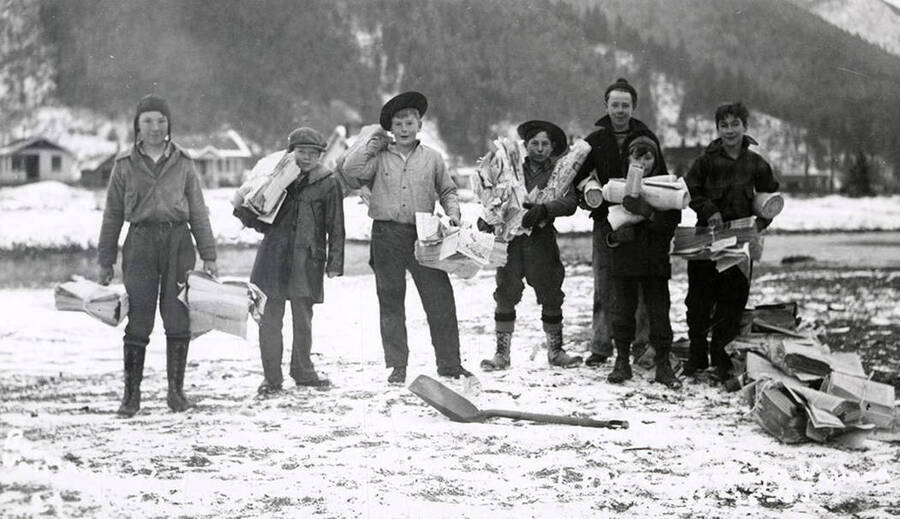 Children holding the first papers to Wallace, Idaho, during the Placer Creek flood.