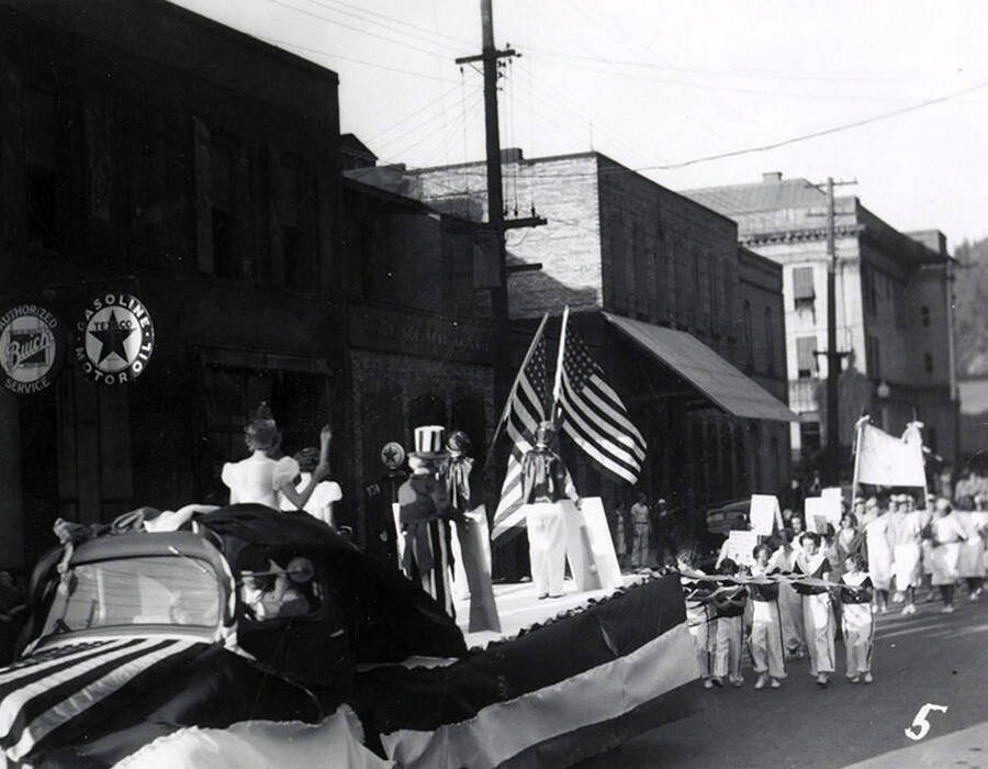 People marching behind a float during the Eagles Parade in Wallace, Idaho.