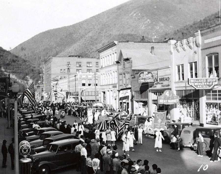 A float being driven, while people stand along the side to watch, during the Eagles Parade in Wallace, Idaho.