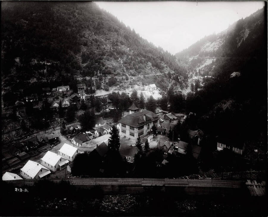 View of the town of Burke, with the school in the center, taken from the hillside. Caption on front: "Masser, John W. - Mining property, Burke Idaho. School in center looking north."
