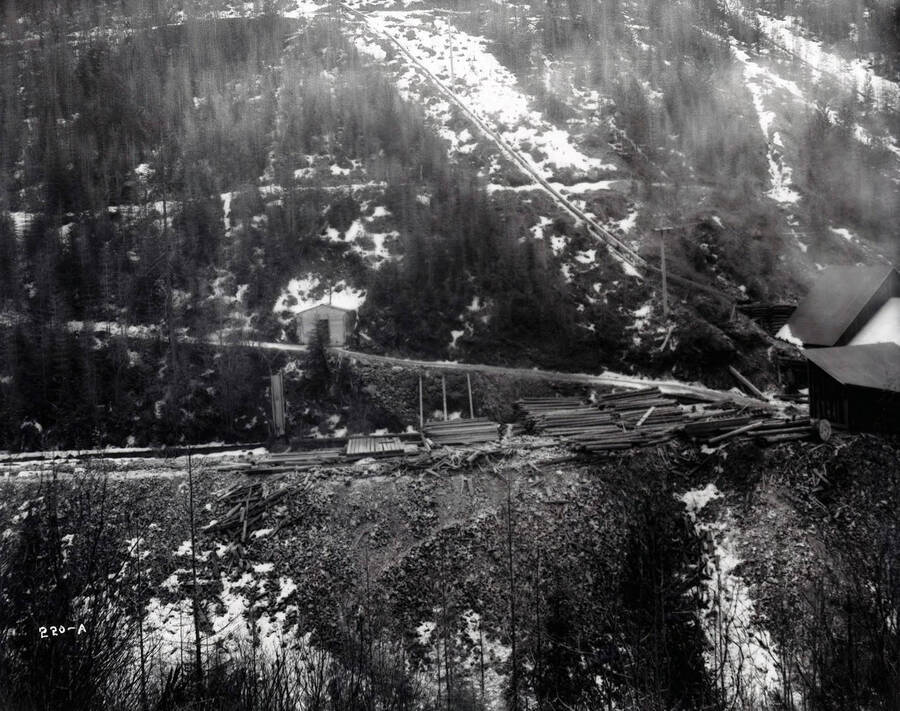 Distant view of the hillside, showing some scattered mine timbers and various outbuildings. Caption on front: "Success Mine, Wallace, Idaho."