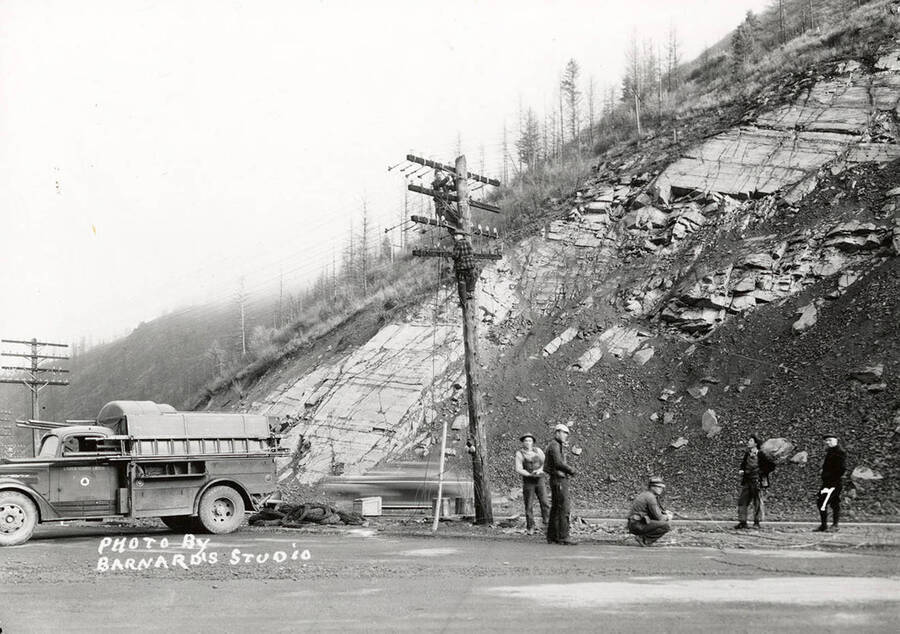 Damage caused by the sunshine powder magazine explosion at the mouth of Big Creek. Crew can be seen working on a power line.