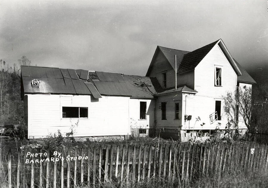 Exterior view of the damage to a house, caused by the sunshine powder magazine explosion at the mouth of Big Creek.
