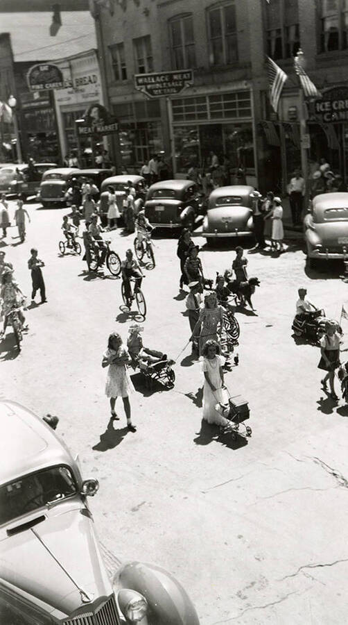 Children walking, and riding bicycles, in the Fourth of July Parade in Wallace, Idaho.