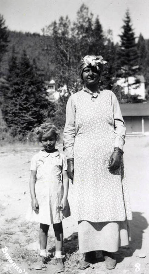 A child, who is in costume, standing next to a woman during the Mullan 49'er parade in Mullan, Idaho.