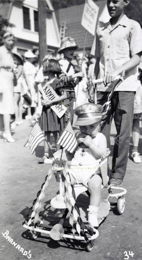 A child, who is in costume, sitting in a stroller during the Mullan 49'er parade in Mullan, Idaho.