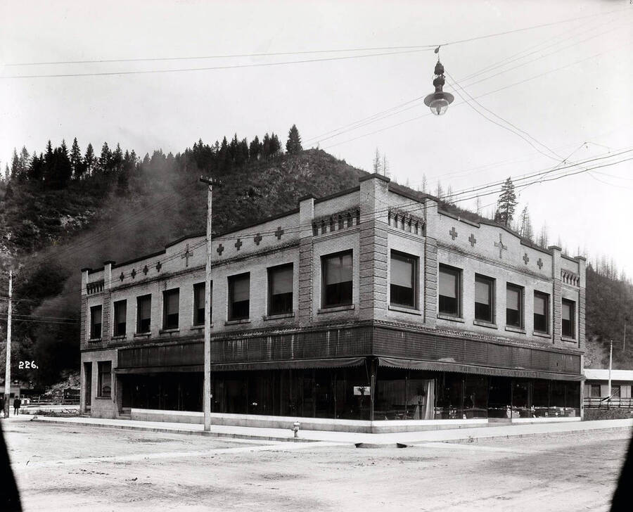 Exterior view of the Worstell Co. Store building. A variety of furnishings and housewares ca be seen through the windows. A street lamp hangs in the foreground of the photo.