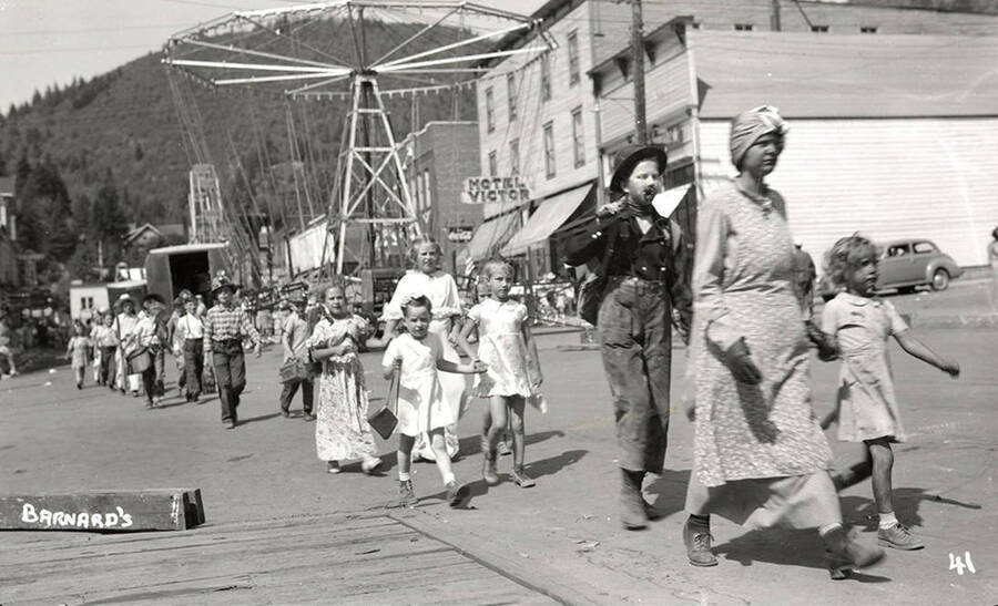 Children, who are in costume, walking in the Mullan 49'er parade in Mullan, Idaho.