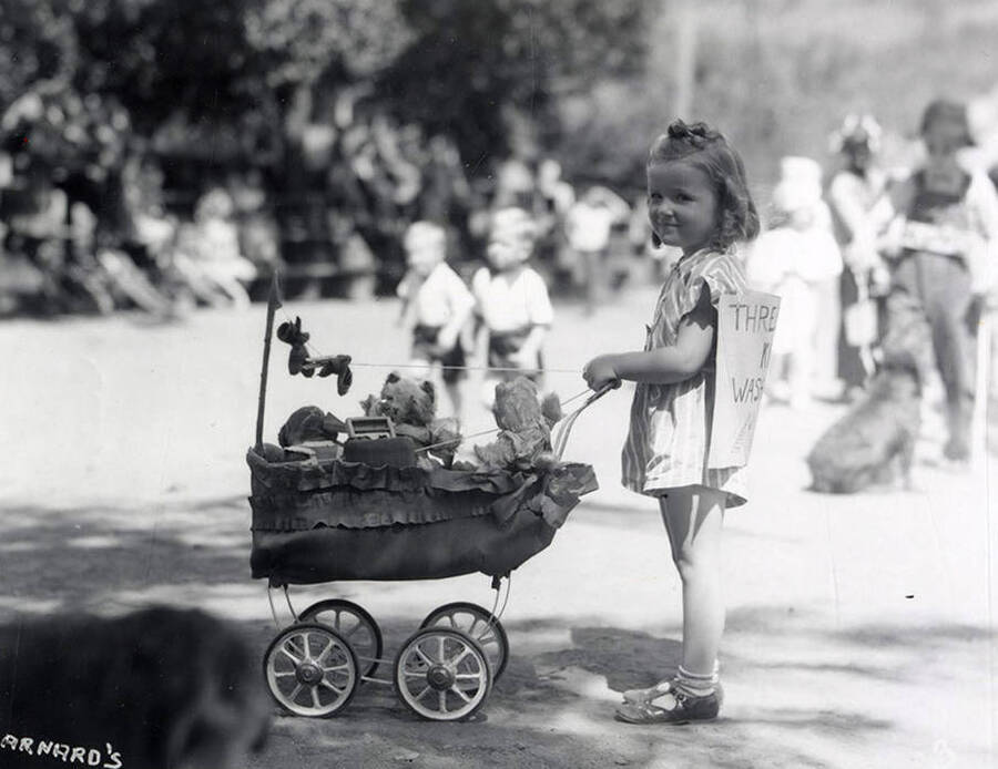 A girl pushing her teddy bears in a stroller during the Wallace pet parade in Wallace, Idaho.