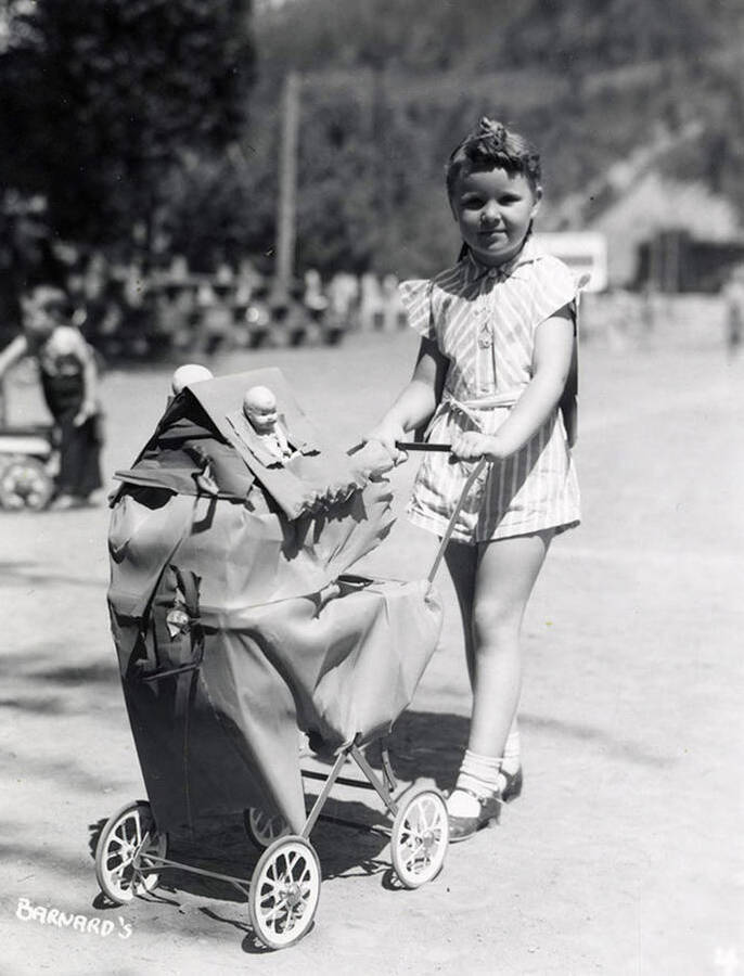 A girl pushing a stroller during the Wallace pet parade in Wallace, Idaho.