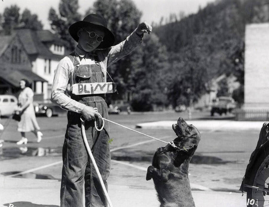 A boy, who are in costume, standing with his dog during the Wallace pet parade in Wallace, Idaho.