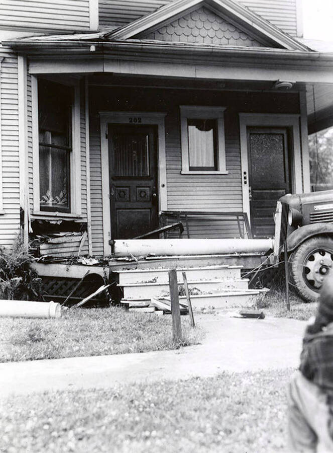 View of a dairy truck wreck. The truck ran into the porch of the Tilford house in Wallace, Idaho.