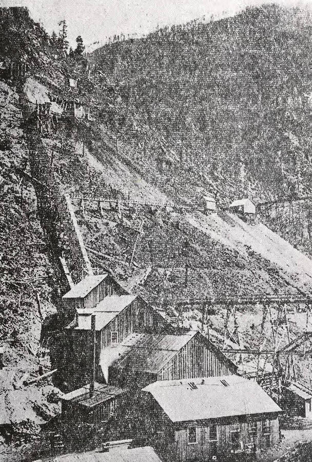Newspaper photo of the Bunker Hill and Sullivan Mill in Wardner, Idaho. This was the first milling plant at Bunker Hill. The mine has since produced $58,260,241 in dividends.