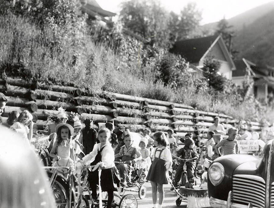 Children in costume riding bicycles during the Slippery Gulch parade in Wallace, Idaho.
