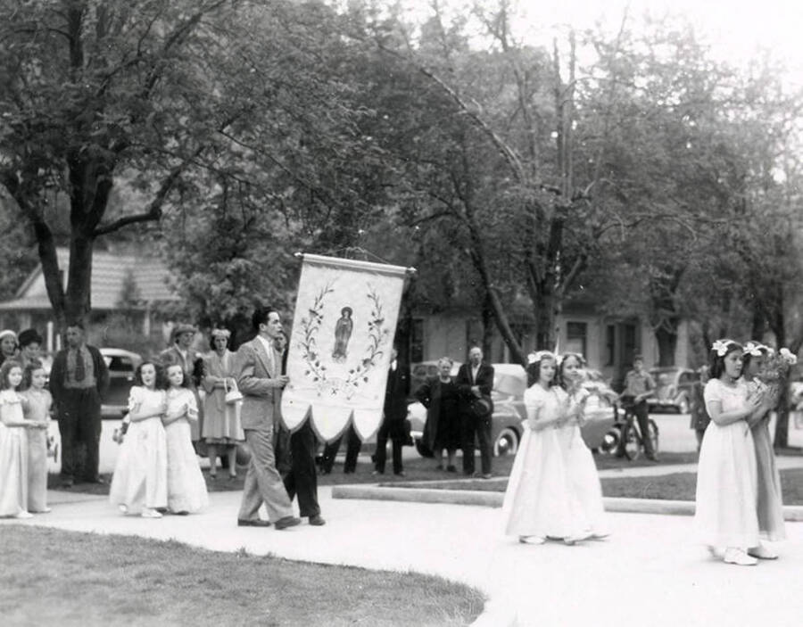 A group of girls marching from the Our Lady of Lourdes Academy to the Church during the Blessed Virgin procession in Wallace, Idaho.