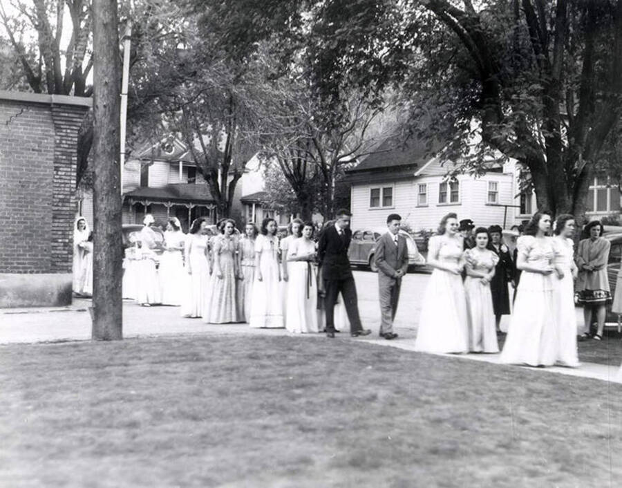 A group of women marching from the Our Lady of Lourdes Academy to the Church during the Blessed Virgin procession in Wallace, Idaho.