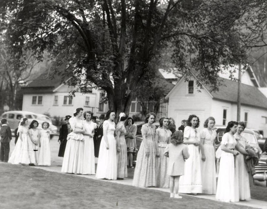 A group of women marching from the Our Lady of Lourdes Academy to the Church during the Blessed Virgin procession in Wallace, Idaho.