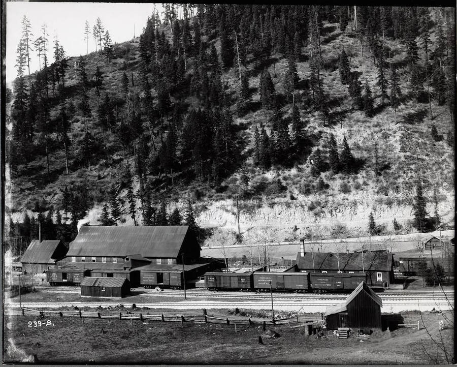 View of the exterior of the Sampler buildings, surrounded by railroad cars.