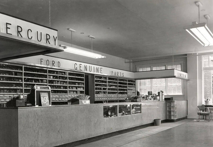 Interior view of the Allison Motor Parts Department in Wallace, Idaho. Various parts can be seen placed on the shelves behind the counter.