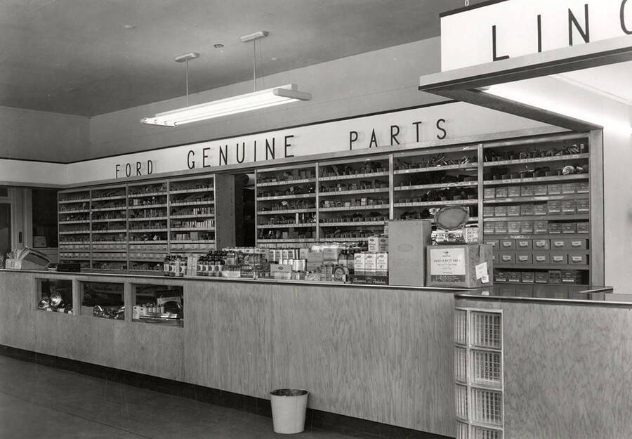 Interior view of the Allison Motor Parts Department in Wallace, Idaho. Various parts can be seen placed on the shelves behind the counter.