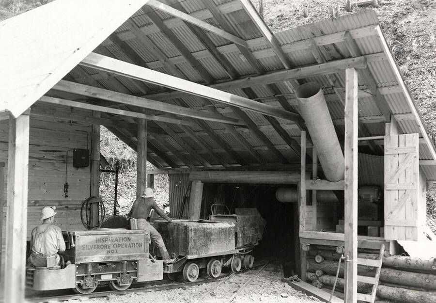 Two men sitting on a cart at the portal of Silverore-Inspiration Silver Mine in Osburn, Idaho. The Inspiration Lead Co. has a working agreement with Silverore Mines, Inc.