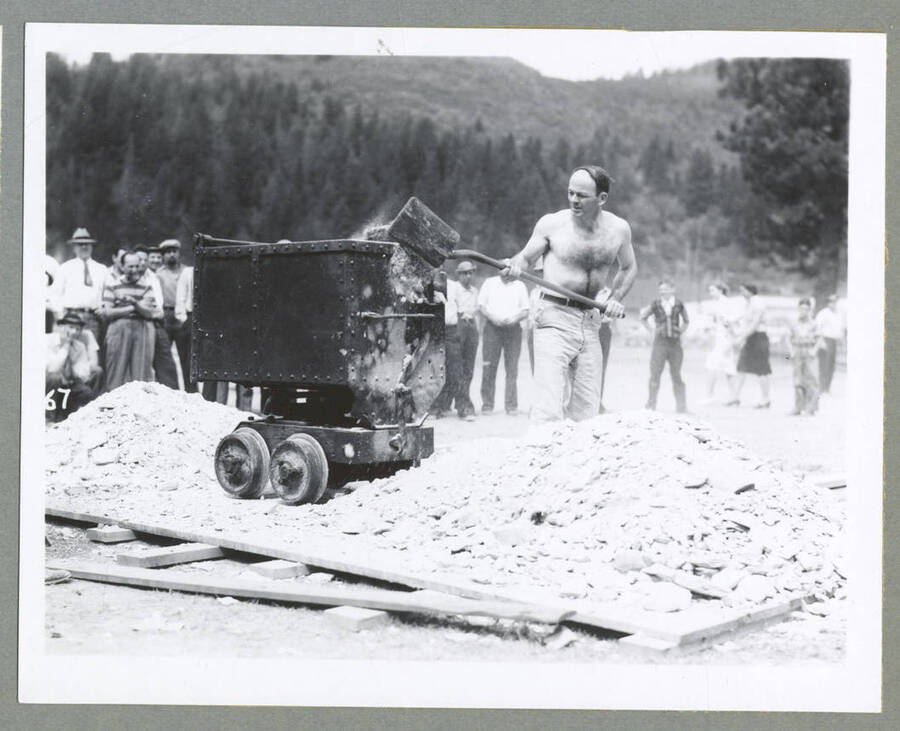 Two men competing in a contest on making holes for blasting powder (also known as singlejacking) during the Mullan '49'er Parade.