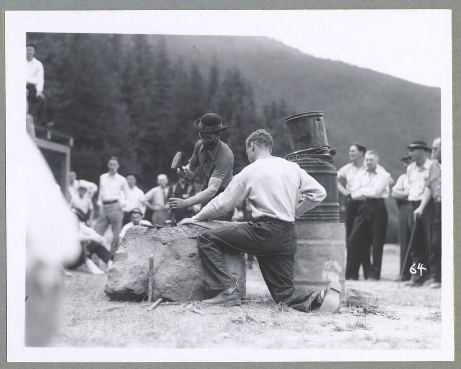 A crowd watches on as men compete in an ore car loading contest during the Mullan '49'er Parade.