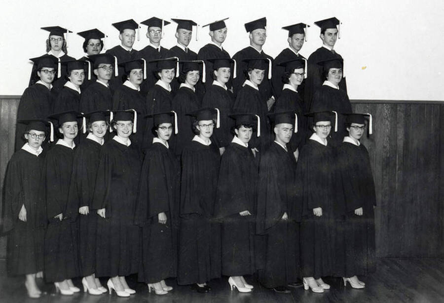 Group photo of the graduating class at Wallace High School in Wallace, Idaho. Back row (left to right): Aljean Wickberg, Violet Ban, Richard Christopherson, Ralph Pribble, Ken Truesdell, Jim Curtis, Bill Jacobson, Bill Lindroos, Terry Murphy. Middle row (left to right): Ruby Raber, Kay Tiffney, Terry Storjohann, Betty Bentham, Christy Terrill, Sara Ann Cooke, Dolores Erickson, Wanda Wolfgram, Mimi Deshler, Lillian Helgeson. Front row (left to right): Barbara Riegel, Gerry Drinnon, Mary Anna Trickey, Carol Anderson, Cecelia Montoya, Aharlotte Carlson, Maureen Allen, Don Hogan, Milli Grant, Bette Jane Olson.