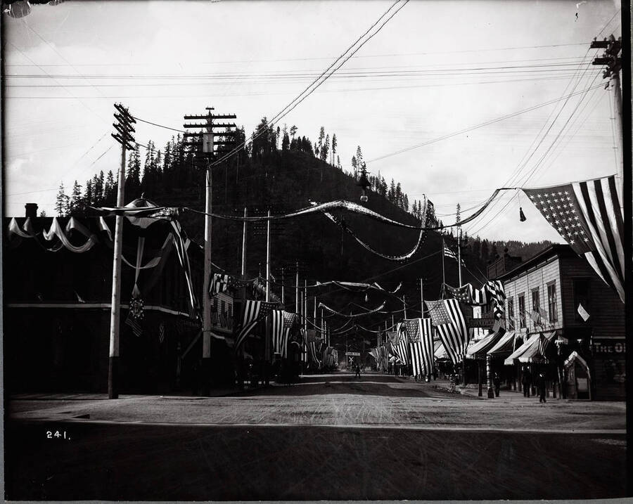 Street in Wallace, Idaho decorated with banners and American flags for the parade processional of President Theodore Roosevelt.
