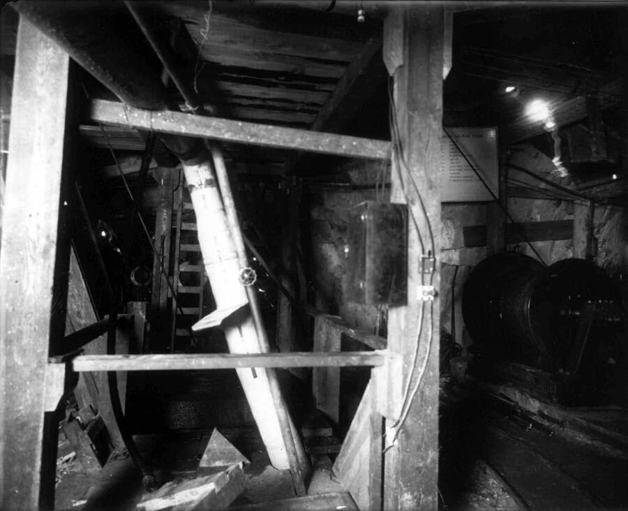 Interior view of Marsh Mine building showing large spool with cable, timbers and pipe (possibly water pipes). Taken Sept. 28, 1910.