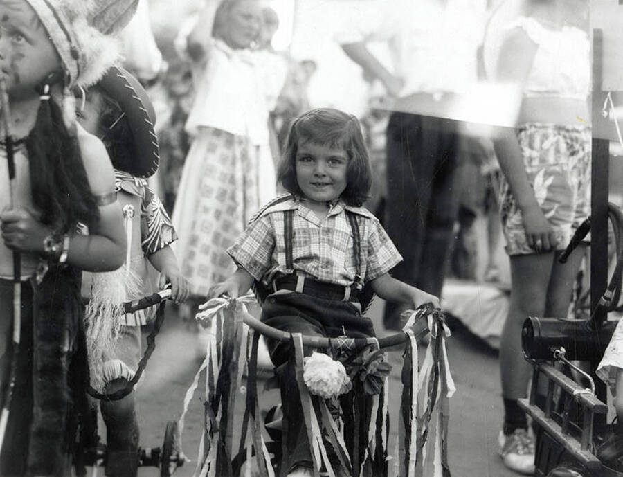A girl riding a bike in the Mullan 49'er Parade in Mullan, Idaho.