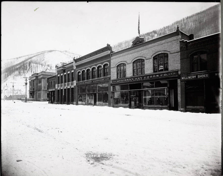 View from across the snow-covered street of the Coeur d'Alene Hardware Co., Otterson Dry Goods Co. and the Idaho Press buildings.