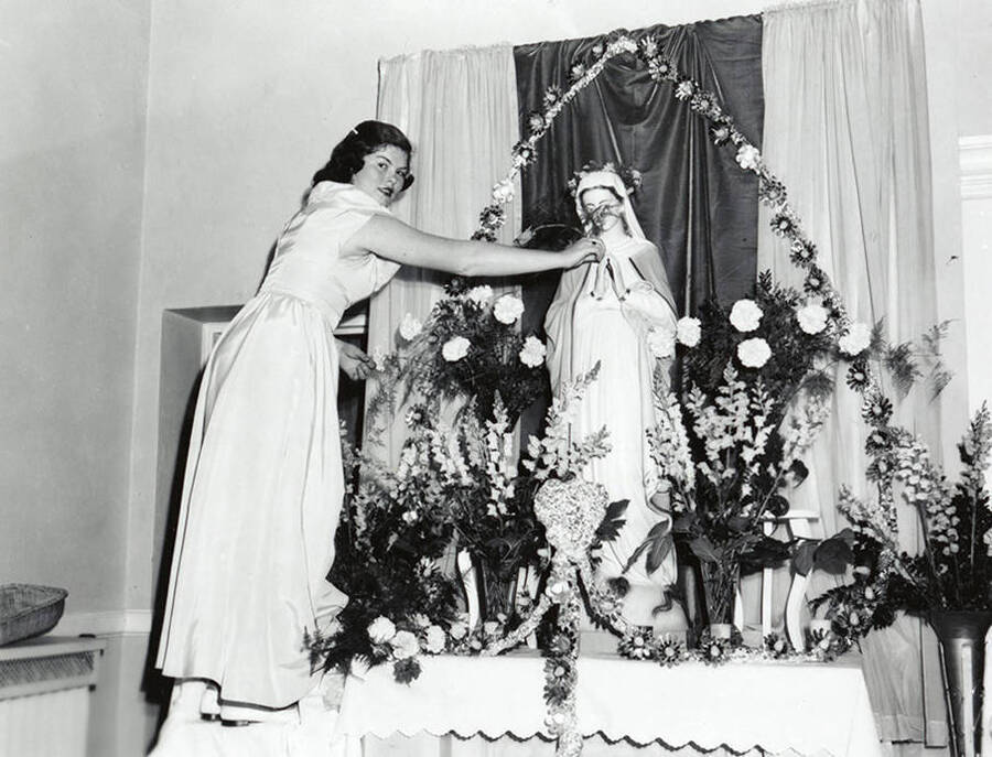 A girl crowning the Virgin Mary at Our Lady of Lourdes Academy in Wallace, Idaho.