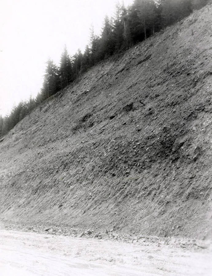 A photograph of an exposed roadside bank. Part of a Colonial Construction Company worksite.