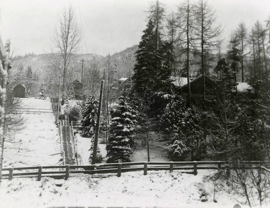 The Fifth Street steps in Wallace, Idaho. The steps and surrounding trees and houses are covered in snow.