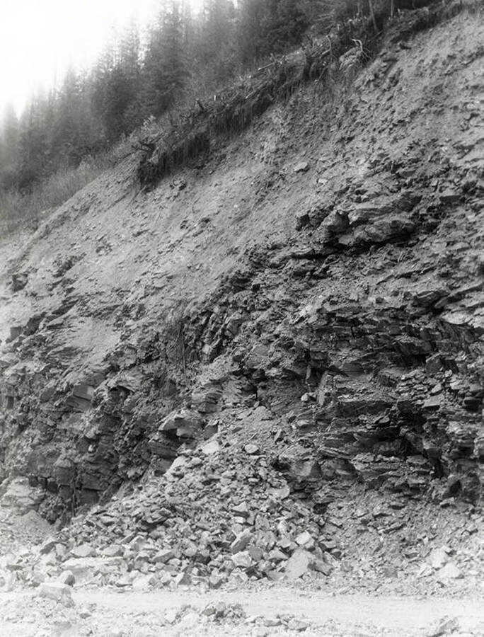 A photograph of an exposed roadside bank. Part of a Colonial Construction Company worksite.