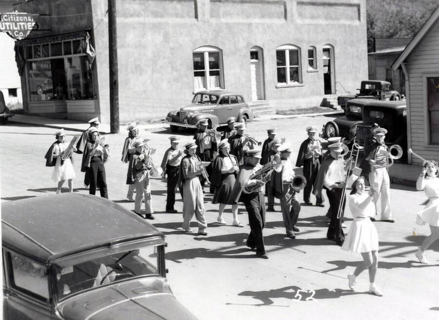 Baton twirlers leading a marching band down the street during the 49'er Parade in Mullan, Idaho.
