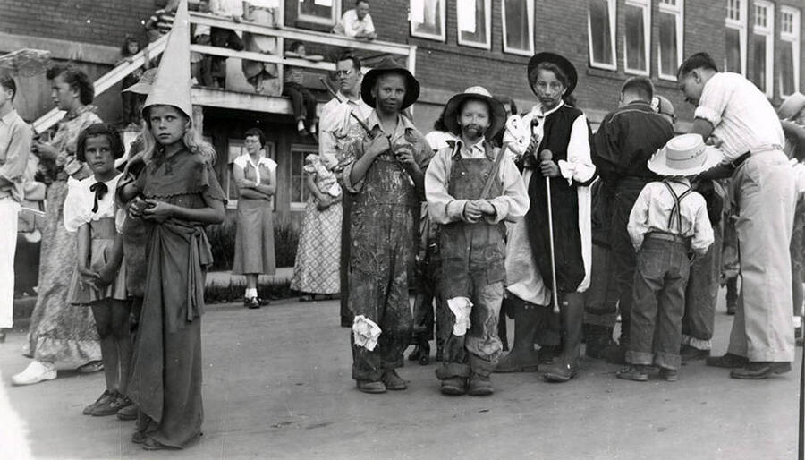 A group of children in costumes posing together during the 49'er Parade in Mullan, Idaho.