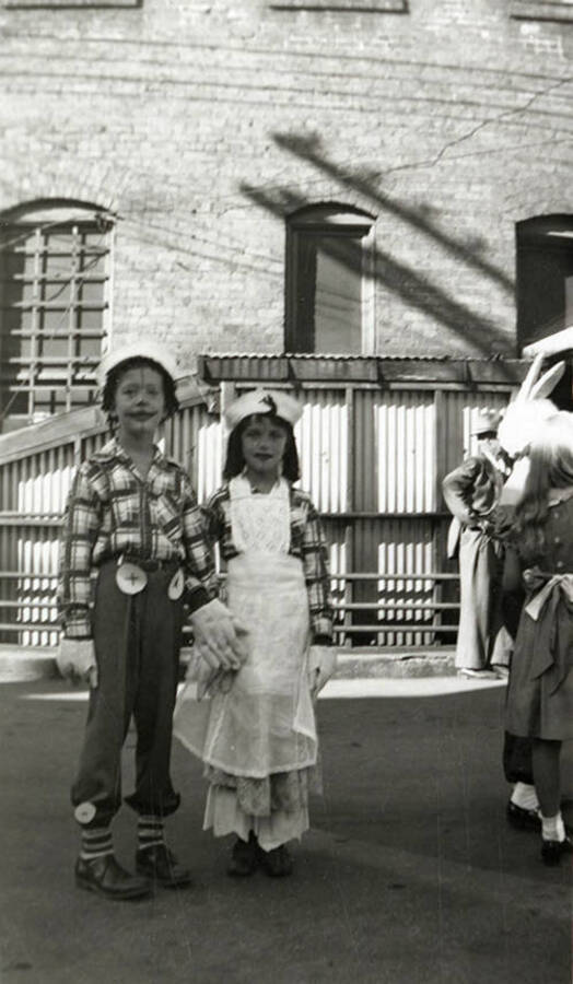 Two children in costume posing together during the Elks Parade in Wallace, Idaho.
