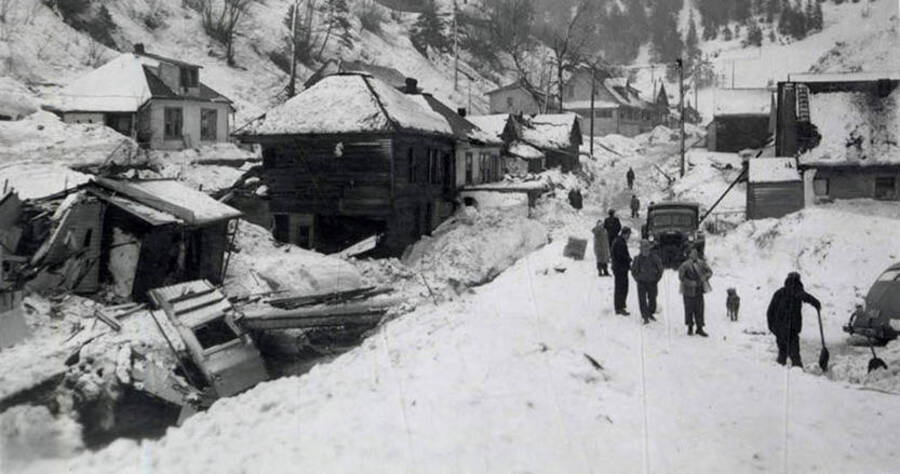 Residents of Mace, Idaho, observing the damage resulting from a snow slide.