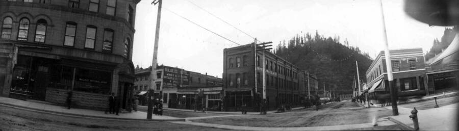 View of a busy street corner in town. Panoramic photograph of Wallace, Idaho.