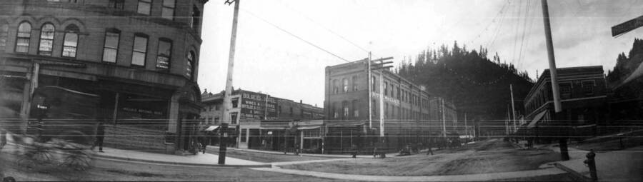 View of a busy street corner in town. Panoramic photograph of Wallace, Idaho.