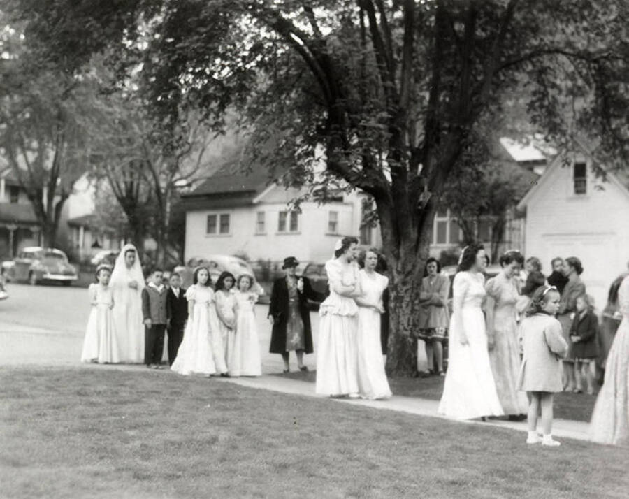 A group of people marching from the Our Lady of Lourdes Academy to the Church during the Blessed Virgin procession in Wallace, Idaho.