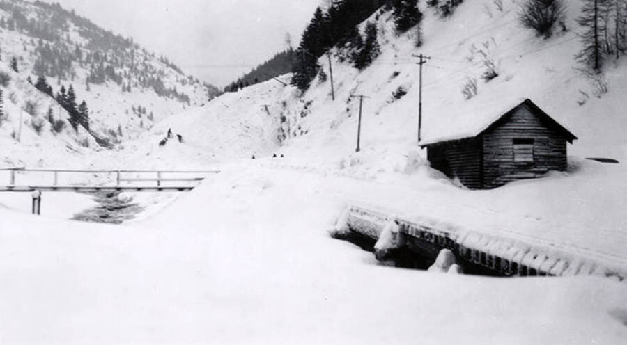 A snow covered bridge and shed in historical Yellow Dog, Idaho, after a snow slide.