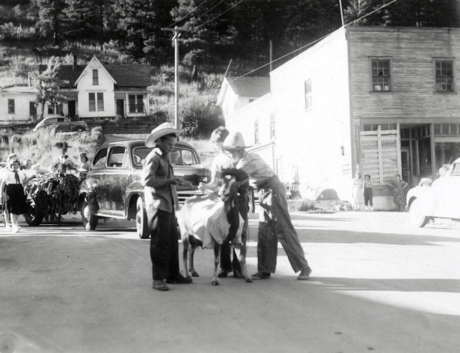 Children standing with a goat for the Mullan 49'er Parade in Mullan, Idaho.