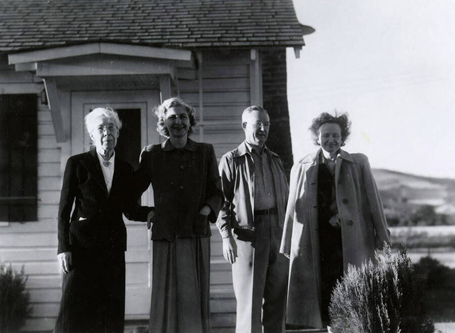 Nellie Stockbridge (1868-1965), left, standing with her family on her farm near Wallace, Idaho.
