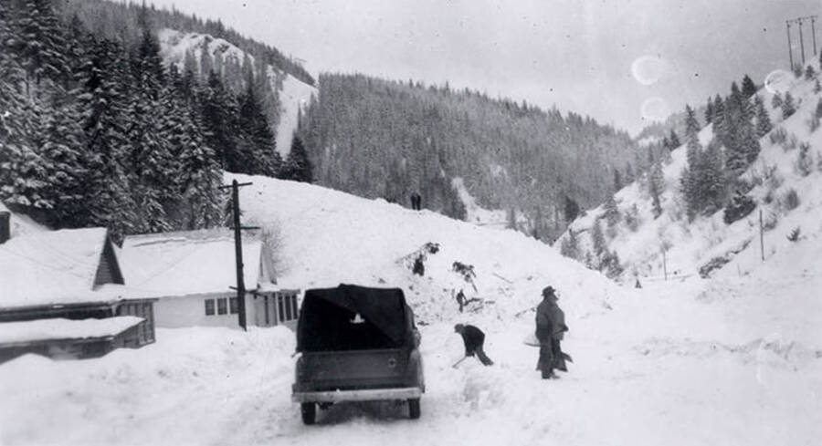 People digging out the main road going into historical Yellow Dog, Idaho, after a snow slide.